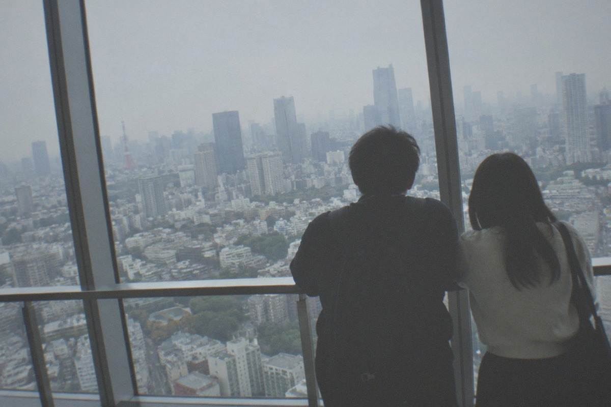 View over Roppongi Hills towers at dusk with Tokyo skyline stretching to the horizon