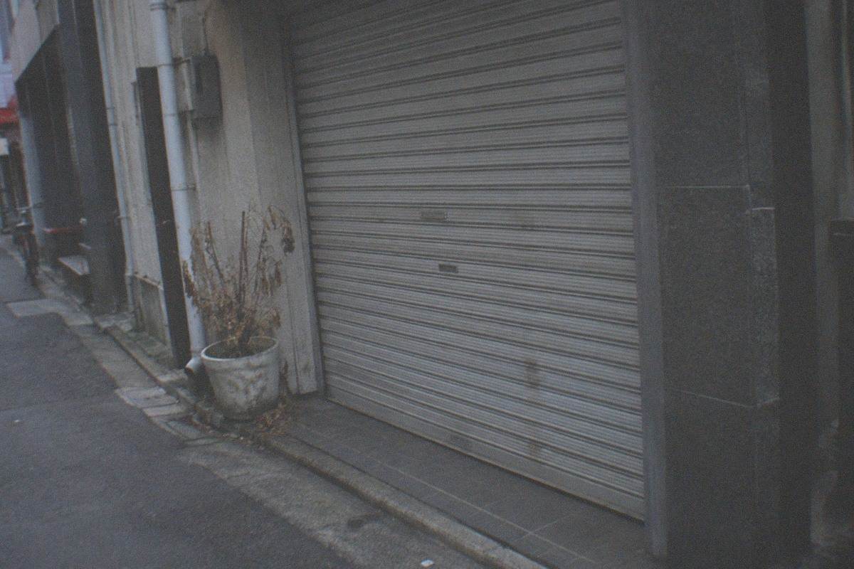 Closed museum entrance in a Shinjuku side street at dusk