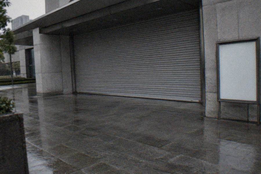 Closed shuttered storefront in the Kabukicho entertainment district at night