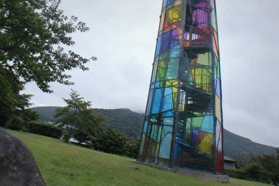 Sculptures displayed on an open lawn at the Hakone Open-Air Museum with forested Hakone hills behind