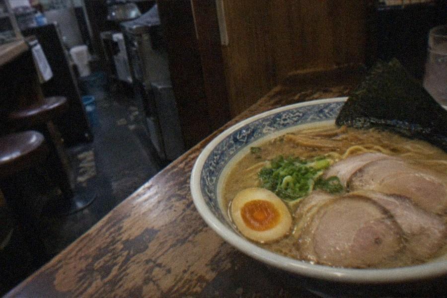 The recreated Showa-era shopping street inside the Shin-Yokohama Ramen Museum, lined with lantern-lit ramen shopfronts