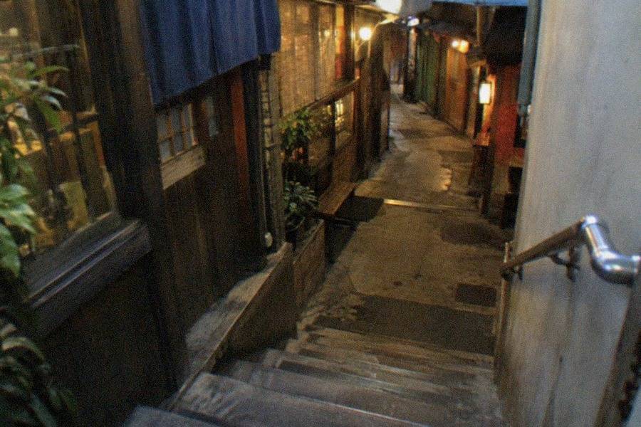 Visitors eating at a counter of one of the ramen shops on the recreated street at the Shin-Yokohama Ramen Museum