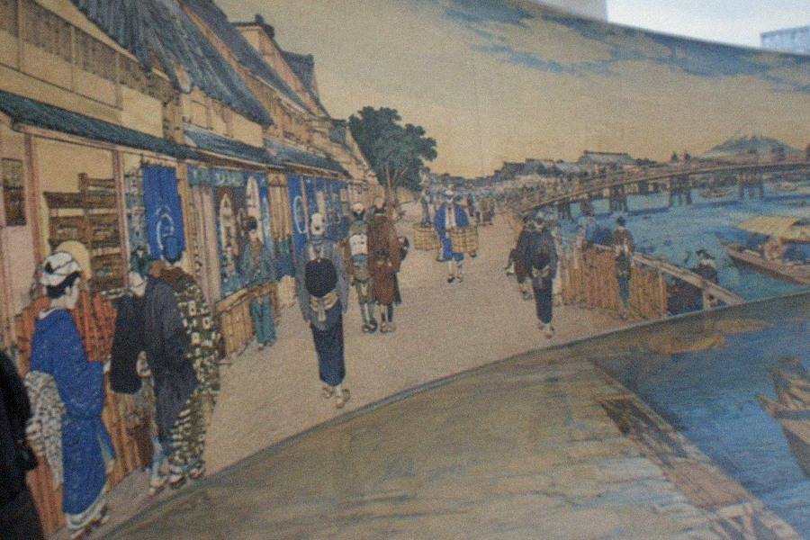 A family posing inside a painted Edo-period street scene at Tokyo Trick Art Museum