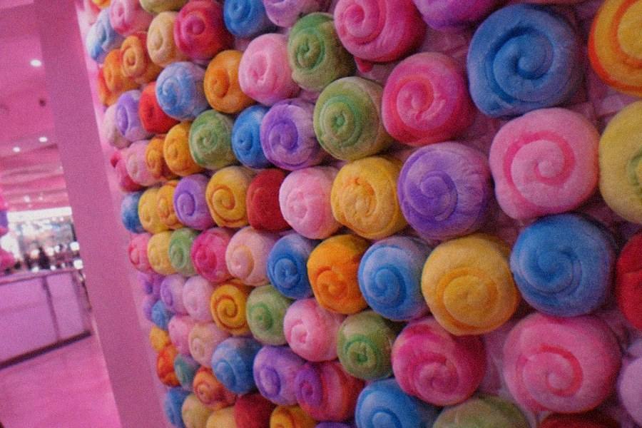 A candy-coloured photo set inside the Unko Museum Tokyo with oversized swirl props and a photo backdrop